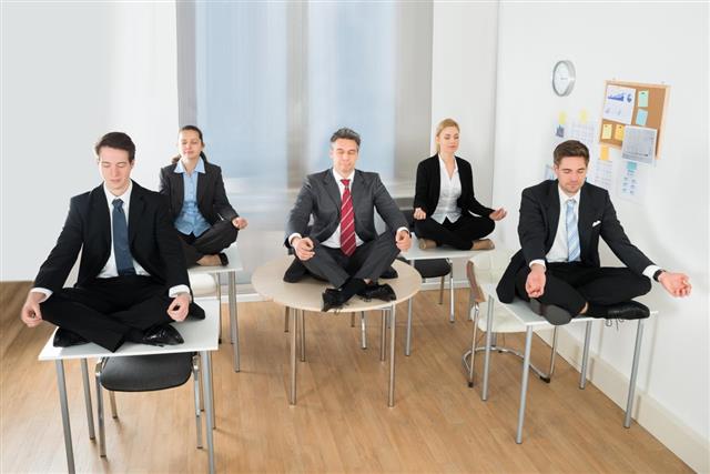 Meditating Business people Sitting On Desk