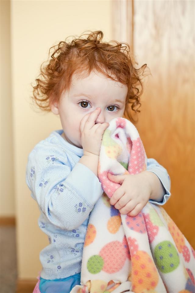 Little Girl Sucking Thumb With Blanket