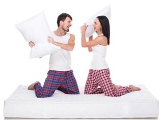 Couple playing with pillows