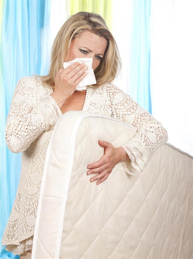 Woman with mattress and allergic symptoms