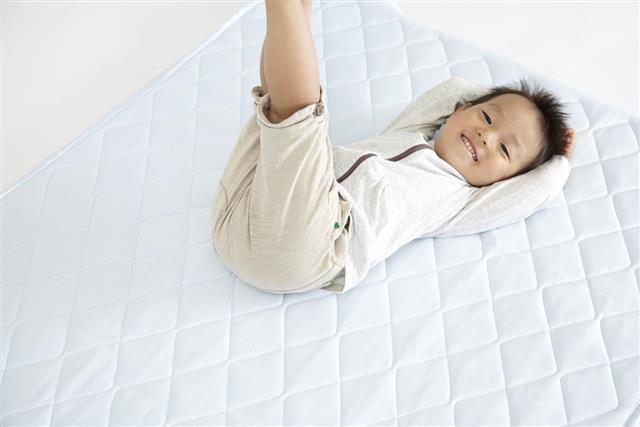 Baby Japanese lie on the mattress man