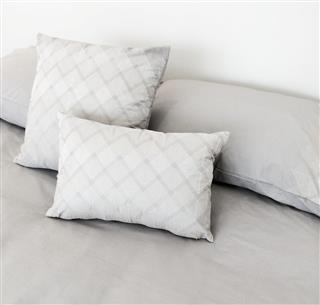 Gray bed linen and pillows