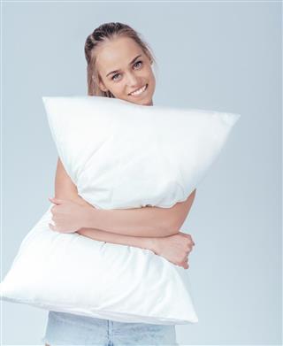 Joyful girl with pillow