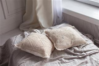 Light openwork pillow on sofa interior decoration in bed room