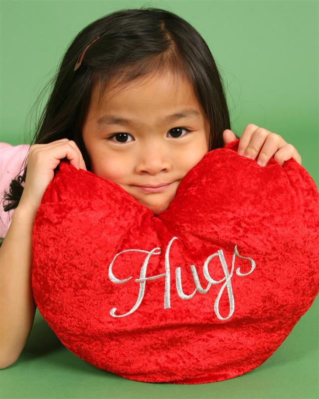 Chinese little girl with Valentine's pillow
