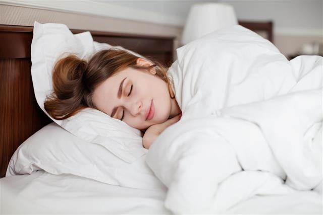 Beautiful healthy woman sleep in hotel number