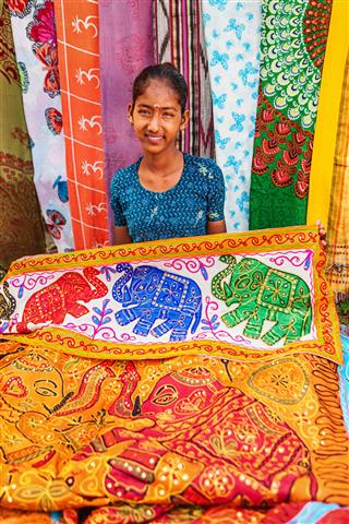Indian Girl Selling Colorful Rugs