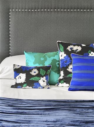 Colorful silk cushions on a bed
