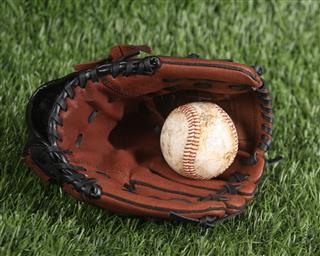 Baseball And Glove On The Grass