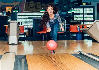 Young Girl Plays Bowling