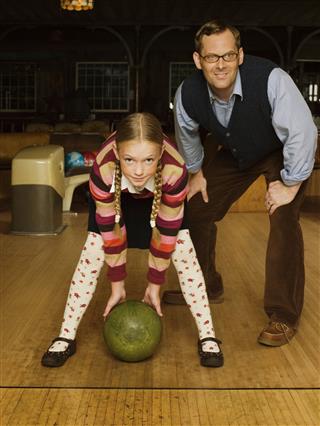 Father And Daughter At Bowling Alley