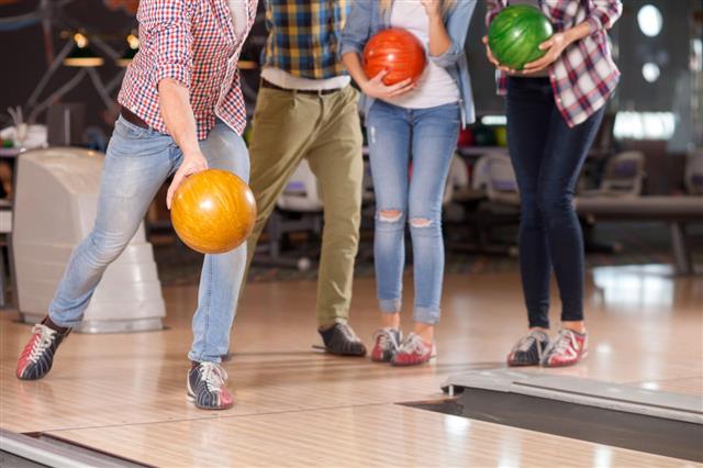 Four Friends Bowling Together