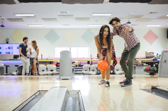 Cheerful Friends Bowling Together