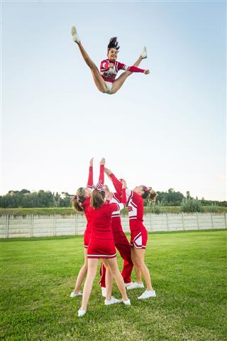 Group Of Cheerleaders Performing Stunts