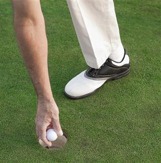 Hand Picking Golf Ball