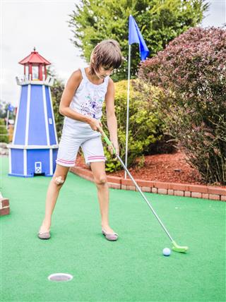 Little Girl Playing Mini Golf