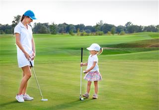 Mother And Daughter Practicing Golf
