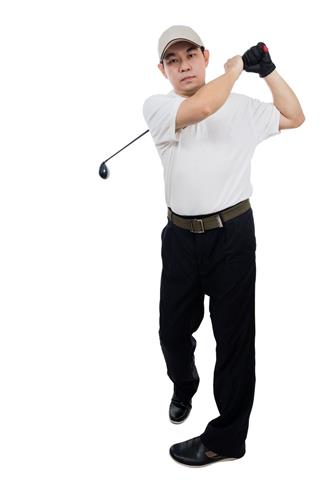 Smiling Man Swinging Golf Club