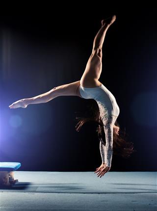 Young Woman Doing Gymnastics Jump