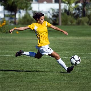 Female Soccer Player Jumps