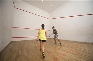 Young Friends Playing Squash On Court