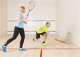 Man And Woman Playing Squash