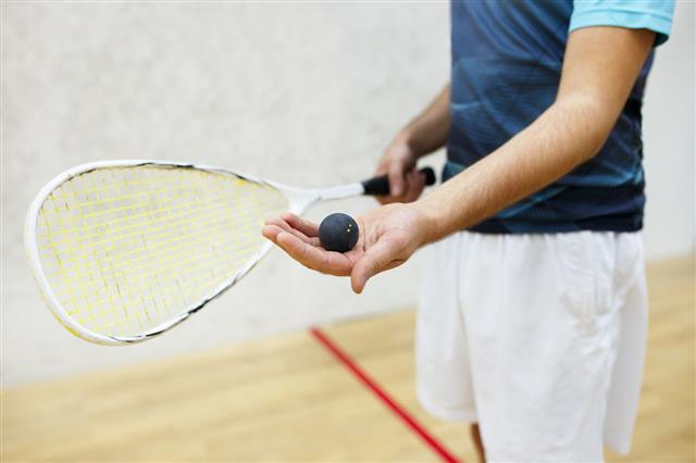 Player Serving A Squash Ball