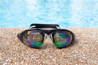 Glasses For Swimming On A Cement Floor With Small Stone
