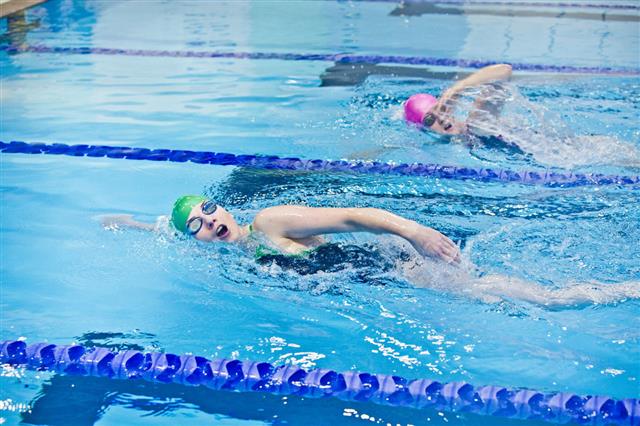 Two Female Athletes Swimming