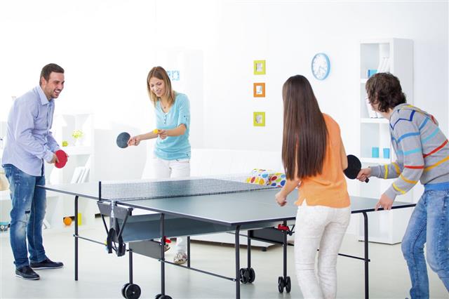 Cheerful Young People Playing Table Tennis