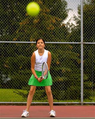 Preteen Girl Playing Tennis