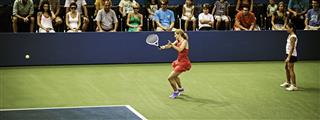Professional Female Tennis Player Hitting Forehand