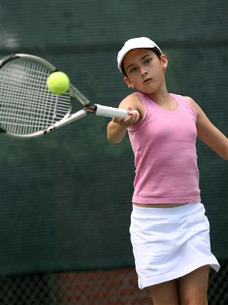 Girl Swinging A Tennis Racket