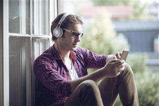 Man Relaxing And Listening Music