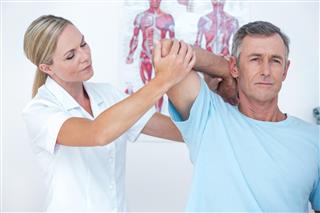 Doctor Stretching Man Arm