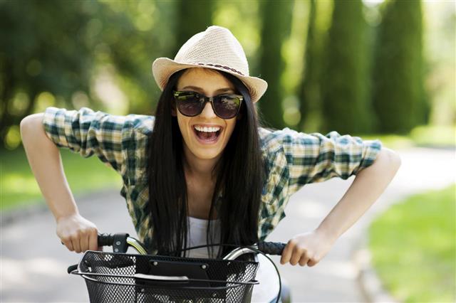 Happy Young Woman With Bicycle