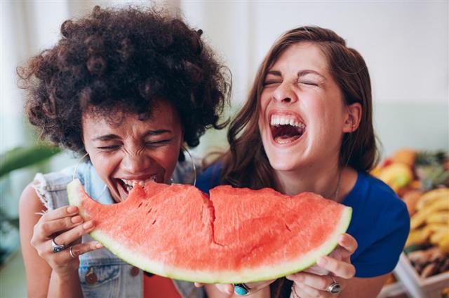 Two Young Girls Enjoying A Watermelon