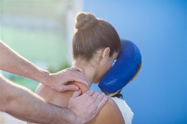 Physiotherapist Giving Shoulder Massage To Patient