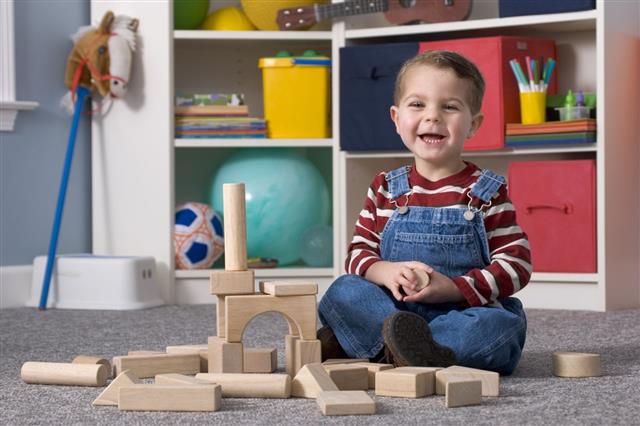 Boy Building Wooden Toy Blocks