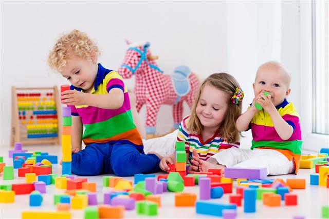 Kids Playing With Colorful Toy