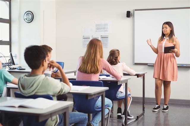 Schoolgirl Giving Presentation In Classroom
