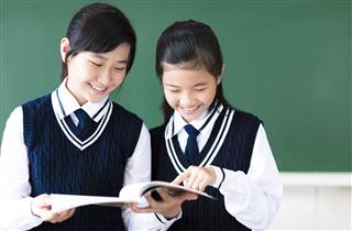 Smiling Teenager Student Girls In Classroom