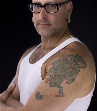 Man with spectacles and tattoo