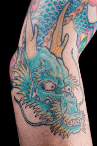 Blue dragon tattoo on arm