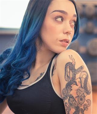 Tattooed woman with blue hair