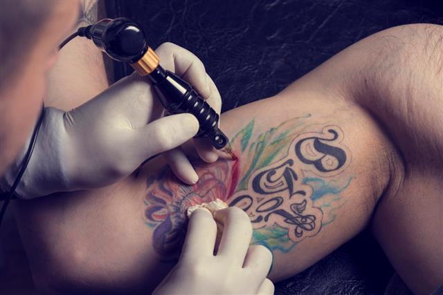 Making tattoo on arm