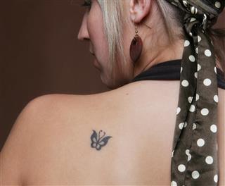 Butterfly tattoo on female back