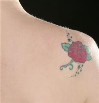 Woman Back with rose tattoo
