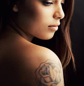 Rose tattoo on girl arm