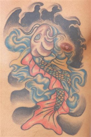 Koi fish tattoo on chest